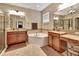 Luxurious bathroom featuring dual vanities, a soaking tub, and granite countertops at 508 Morgan Wood Dr, Deland, FL 32724