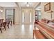 Bright foyer with tile flooring, a decorative chandelier, and a view into the dining area and living spaces at 508 Morgan Wood Dr, Deland, FL 32724
