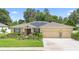 Attractive single-story home with a three-car garage, solar panels and meticulous landscaping enhancing its curb appeal at 508 Morgan Wood Dr, Deland, FL 32724