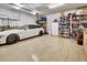 Spacious garage with epoxy floors, shelving, and a white car at 508 Morgan Wood Dr, Deland, FL 32724