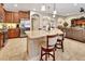 Open kitchen with a large island, granite countertops, and seating, flowing into the living area at 508 Morgan Wood Dr, Deland, FL 32724
