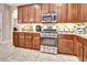 Gourmet kitchen featuring stainless steel appliances, granite countertops, and ample cabinet space at 508 Morgan Wood Dr, Deland, FL 32724