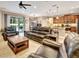 Comfortable living room with leather seating, ceiling fan, and sliding glass doors to the outdoor space at 508 Morgan Wood Dr, Deland, FL 32724