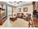 Cozy living room featuring comfortable leather seating, a wooden coffee table, and a TV unit with a large screen at 508 Morgan Wood Dr, Deland, FL 32724