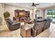 Inviting living room featuring leather seating, entertainment center, and access to the outdoor area at 508 Morgan Wood Dr, Deland, FL 32724