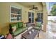 Covered patio features comfortable seating, a ceiling fan, and a view of the lush backyard, perfect for relaxation at 508 Morgan Wood Dr, Deland, FL 32724