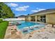 Stunning backyard with a large pool, spa, and submerged lounge chairs, perfect for luxurious outdoor living at 508 Morgan Wood Dr, Deland, FL 32724