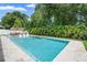 Refreshing pool and spa with poolside seating, lush landscaping, and serene privacy at 508 Morgan Wood Dr, Deland, FL 32724
