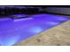 Backyard pool and hot tub illuminated with color-changing lights, perfect for evening relaxation at 508 Morgan Wood Dr, Deland, FL 32724