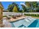 Backyard pool featuring a tanning ledge with in-pool loungers and an outdoor seating area at 508 Morgan Wood Dr, Deland, FL 32724