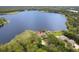 Beautiful aerial view of a lakeside house with a backdrop of a serene lake at 510 Sandy Bluff Trl, Deland, FL 32724