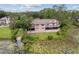 A lakeside home featuring a screened lanai and lush greenery at 510 Sandy Bluff Trl, Deland, FL 32724