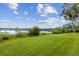 Expansive green lawn leading to a tranquil lake, a perfect setting at 510 Sandy Bluff Trl, Deland, FL 32724