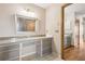 A bathroom vanity area with a large mirror, drawers, and tiled flooring at 510 Sandy Bluff Trl, Deland, FL 32724