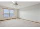 This serene bedroom offers a large window with a view, carpeted floors, and a ceiling fan at 510 Sandy Bluff Trl, Deland, FL 32724