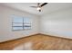 Bright, empty bedroom with light hardwood floors, a window with nice outdoor view, and a ceiling fan at 510 Sandy Bluff Trl, Deland, FL 32724
