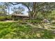 Community clubhouse surrounded by beautiful landscaping and mature trees with playground nearby at 510 Sandy Bluff Trl, Deland, FL 32724