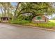 The Trails West brick community sign is beautifully landscaped under a canopy of mature trees at 510 Sandy Bluff Trl, Deland, FL 32724
