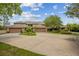 A well-maintained property with lush landscaping and a large driveway leading to multiple garages at 510 Sandy Bluff Trl, Deland, FL 32724
