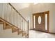 Bright, tiled foyer with a staircase and a wooden door with glass accents at 510 Sandy Bluff Trl, Deland, FL 32724