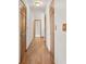 A well-lit hallway features wood floors and multiple closet doors, offering ample storage space at 510 Sandy Bluff Trl, Deland, FL 32724
