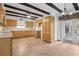 Kitchen featuring wood cabinets, tile backsplash, decorative ceiling beams and an exterior door at 510 Sandy Bluff Trl, Deland, FL 32724