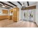 Open kitchen with wooden cabinets, wood flooring, wooden beams and glass doors leading to the backyard at 510 Sandy Bluff Trl, Deland, FL 32724