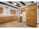 Kitchen featuring wood cabinets, tile backsplash and decorative ceiling beams at 510 Sandy Bluff Trl, Deland, FL 32724