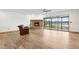 Large living room with hardwood floors, a fireplace, and sliding doors leading to a balcony at 510 Sandy Bluff Trl, Deland, FL 32724