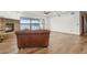 Spacious living room with hardwood floors, a brick fireplace, and access to the outdoor balcony at 510 Sandy Bluff Trl, Deland, FL 32724
