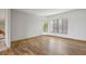 Bright living room featuring wood floors, a wall of windows, and neutral paint at 510 Sandy Bluff Trl, Deland, FL 32724