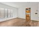 Well-lit living room with wood flooring, neutral walls, and a view into the kitchen at 510 Sandy Bluff Trl, Deland, FL 32724