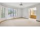 Spacious main bedroom with carpet, a ceiling fan, and an en-suite bathroom at 510 Sandy Bluff Trl, Deland, FL 32724