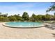 Inviting community pool surrounded by lush landscaping and comfortable lounge chairs at 510 Sandy Bluff Trl, Deland, FL 32724