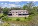 Rear exterior of home with screened patios overlooking the lake at 510 Sandy Bluff Trl, Deland, FL 32724