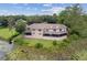 Aerial view showcasing the backyard, mature trees, and lake of this house at 510 Sandy Bluff Trl, Deland, FL 32724