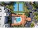 Aerial view of the community pool and tennis courts surrounded by condos at 5300 S Atlantic Ave # 12-401, New Smyrna Beach, FL 32169