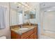 Bathroom with a granite countertop, a sink and access to a shower area at 5300 S Atlantic Ave # 12-401, New Smyrna Beach, FL 32169