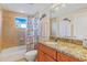 Bathroom featuring vanity with granite countertop and tub with shower at 5300 S Atlantic Ave # 12-401, New Smyrna Beach, FL 32169