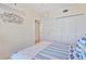 The bedroom features a closet and ensuite bathroom with beach-themed decor at 5300 S Atlantic Ave # 12-401, New Smyrna Beach, FL 32169