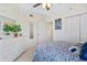 Bright bedroom with a ceiling fan, dresser with a mirror, and paisley bedding at 5300 S Atlantic Ave # 12-401, New Smyrna Beach, FL 32169