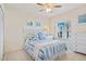 Well-lit bedroom featuring seaside themed decor and natural light from the window at 5300 S Atlantic Ave # 12-401, New Smyrna Beach, FL 32169