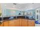 Kitchen with granite countertops and cabinetry overlooking the living room at 5300 S Atlantic Ave # 12-401, New Smyrna Beach, FL 32169