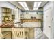 The kitchenette features custom cabinets, granite counters, mosaic backsplash and stainless appliances at 5300 S Atlantic Ave # 12-401, New Smyrna Beach, FL 32169