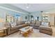 Comfortable living room with large windows, plush seating, and stylish decor at 5300 S Atlantic Ave # 12-401, New Smyrna Beach, FL 32169