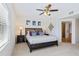 This main bedroom has a decorative ceiling fan and an ensuite bathroom with step-in shower at 5300 S Atlantic Ave # 12-401, New Smyrna Beach, FL 32169