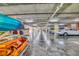 Spacious parking garage with ample lighting; kayaks are stored in a rack at 5300 S Atlantic Ave # 12-401, New Smyrna Beach, FL 32169