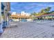 Inviting community pool area with lounge chairs, covered seating, and palm trees on a sunny day at 5300 S Atlantic Ave # 12-401, New Smyrna Beach, FL 32169