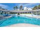 Community pool featuring a covered pool house and a lounging area at 5300 S Atlantic Ave # 12-401, New Smyrna Beach, FL 32169