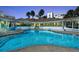 Beautiful pool and clubhouse in a serene setting, perfect for relaxing and socializing at 5300 S Atlantic Ave # 12-401, New Smyrna Beach, FL 32169